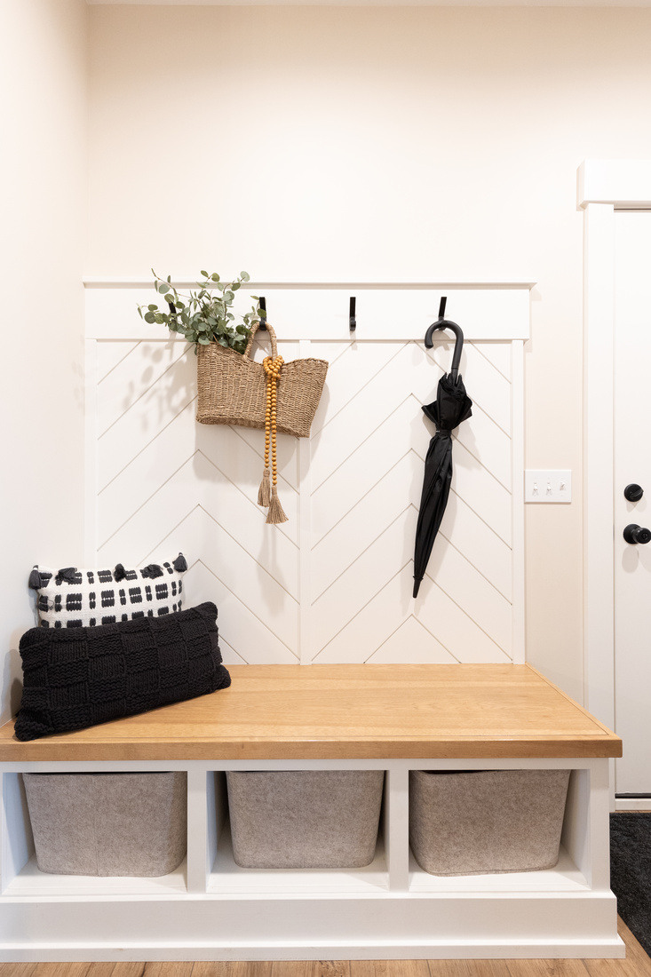 Mudroom bench with built-in storage and wall hooks in Ridgewood Home Construction’s West Michigan remodel