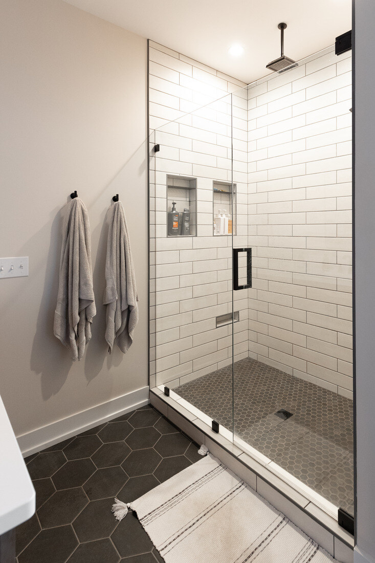 Walk-in glass shower with subway tile in West Michigan bathroom remodel by Ridgewood Home Construction