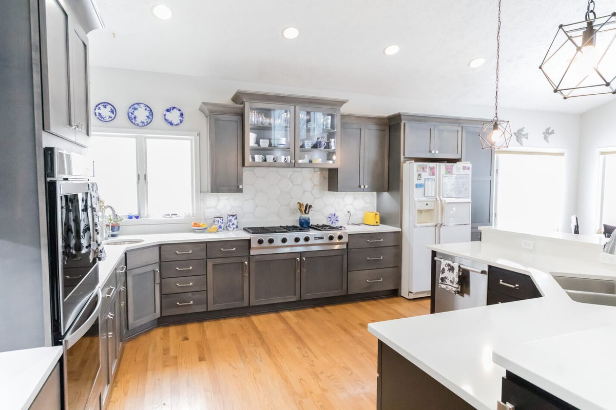 Bright kitchen layout with decorative plates and stove wall in Cascade remodel by Ridgewood Home Construction
