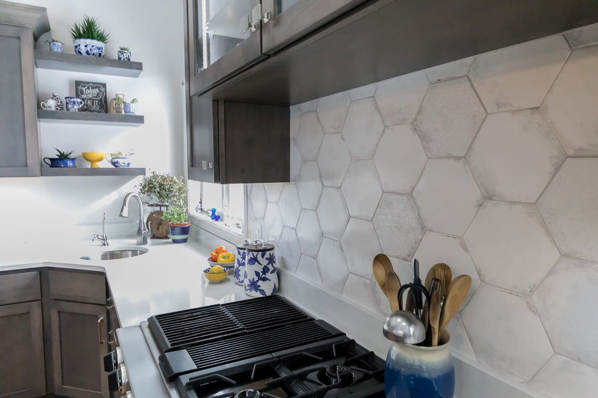Close-up of hexagon backsplash and cooktop area in Cascade kitchen remodel by Ridgewood Home Construction