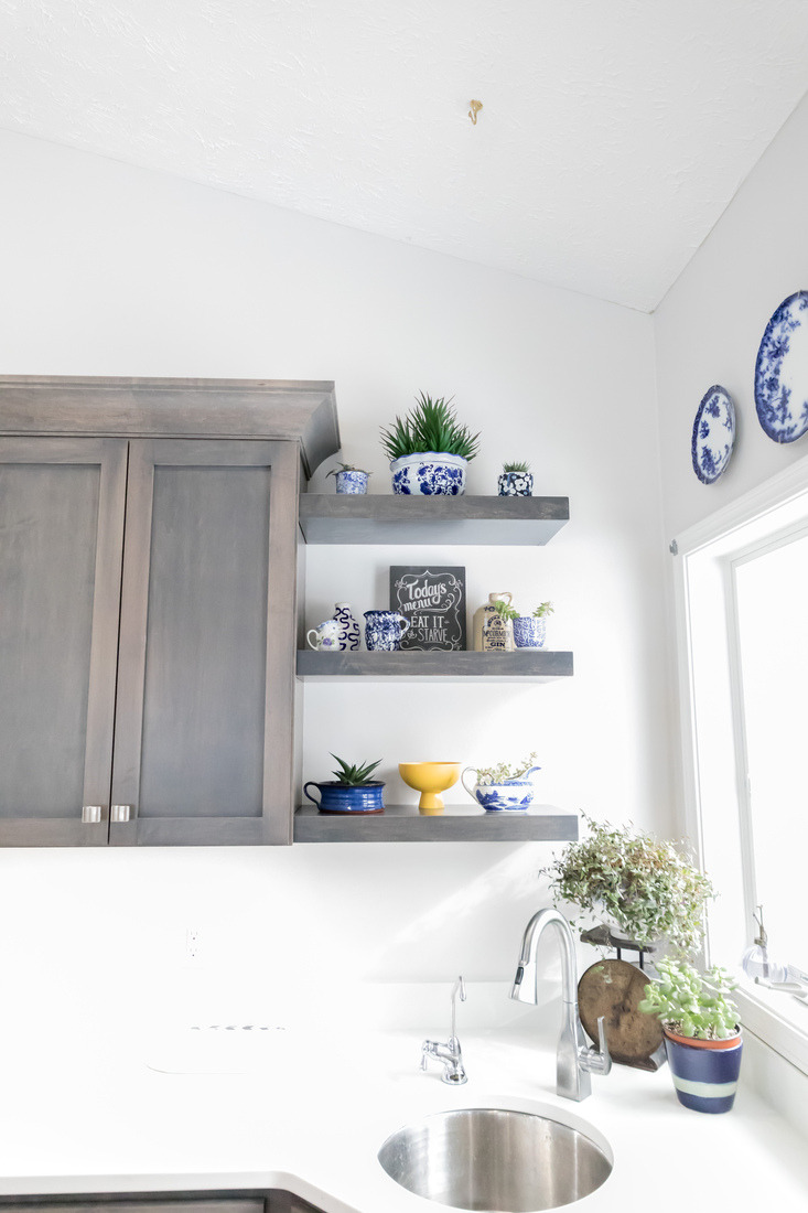 Floating kitchen shelves with blue and white pottery in Cascade remodel by Ridgewood Home Construction