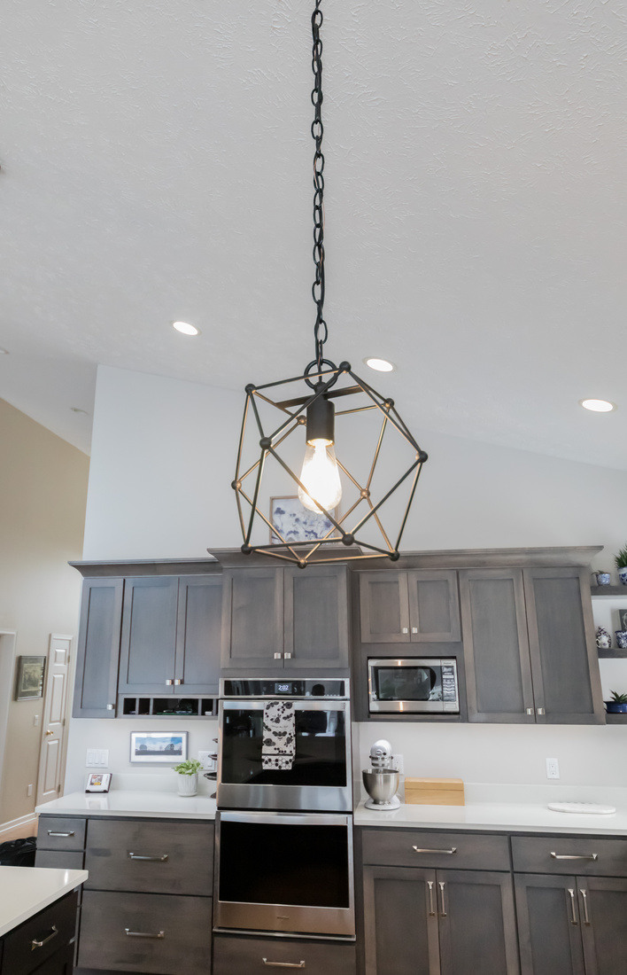 Pendant light fixture above Cascade kitchen island by Ridgewood Home Construction