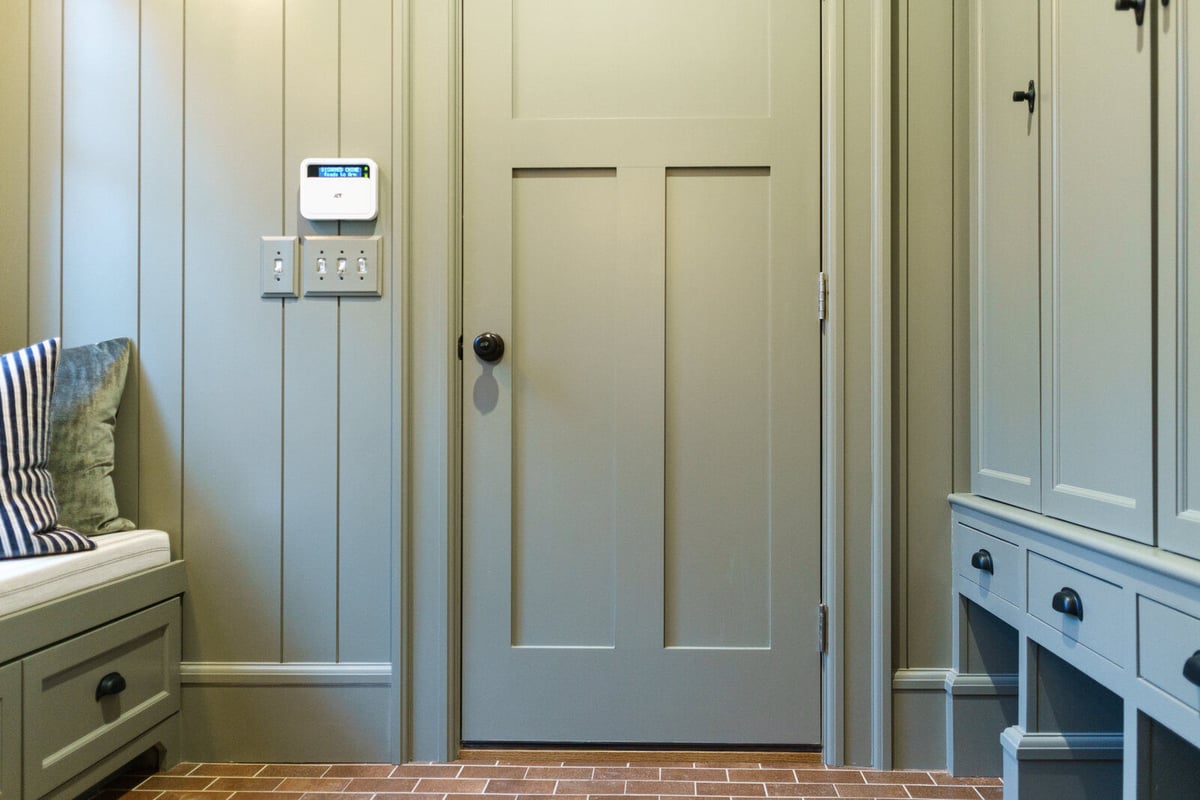Custom mudroom renovation with shaker cabinetry and brick floor by Ridgewood Home Construction in East Grand Rapids