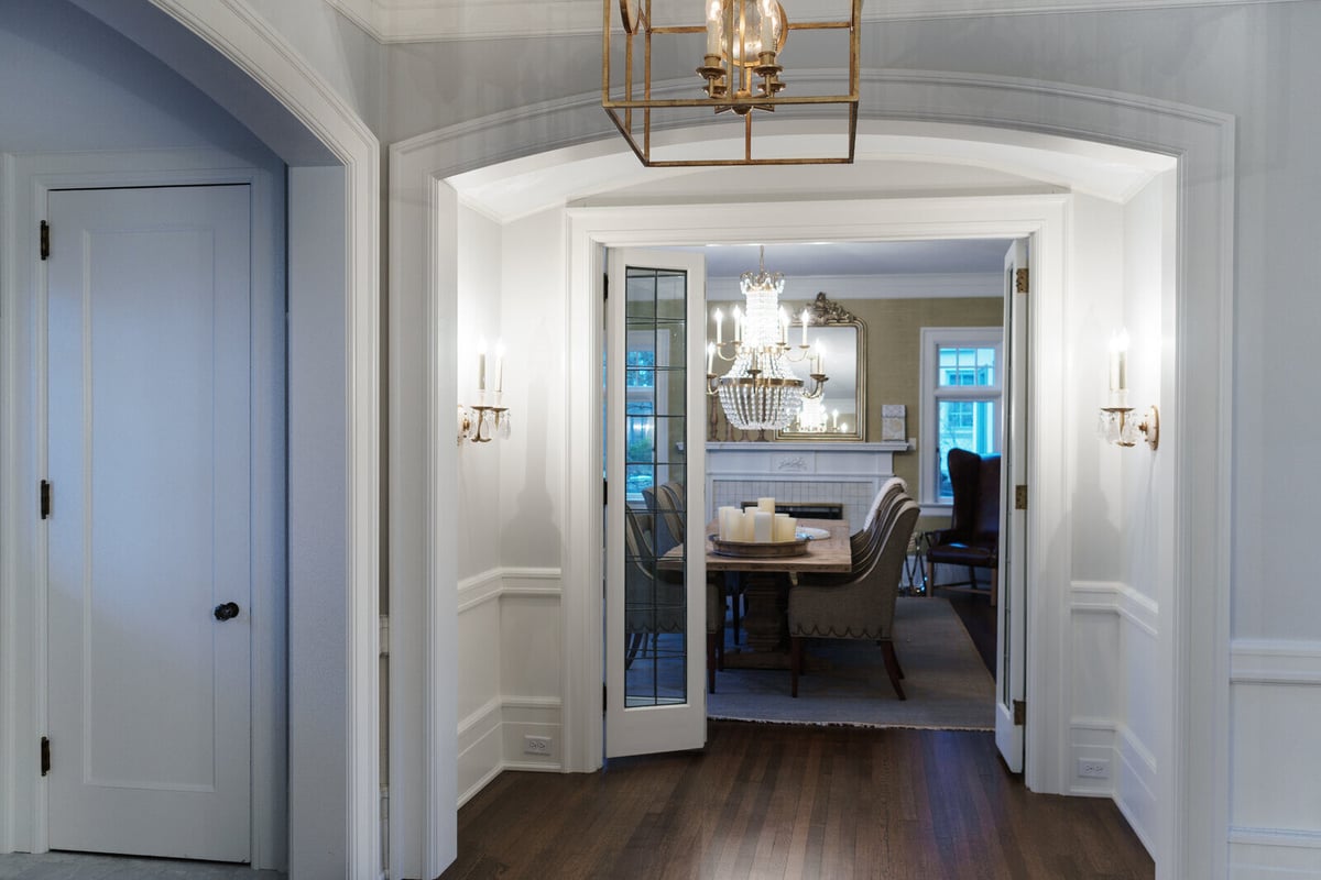 East Grand Rapids dining room renovation with chandelier and French doors by Ridgewood Home Construction