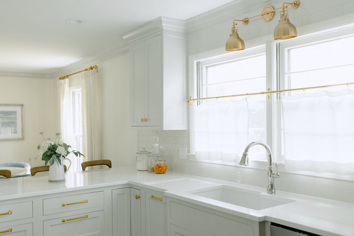 East Grand Rapids kitchen corner featuring shaker cabinets and gold wall sconces by Ridgewood Home Construction