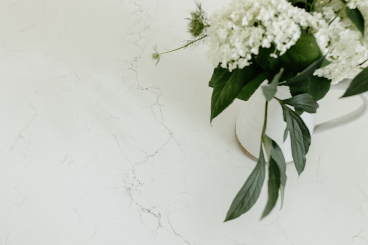 White quartz kitchen countertop with floral arrangement in East Grand Rapids by Ridgewood Home Construction