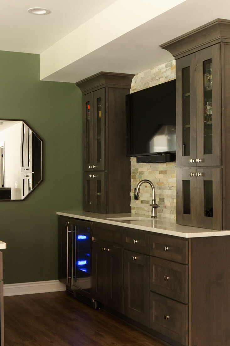 Side view of remodeled basement wet bar with beverage fridge in Grand Rapids Township by Ridgewood Home Construction