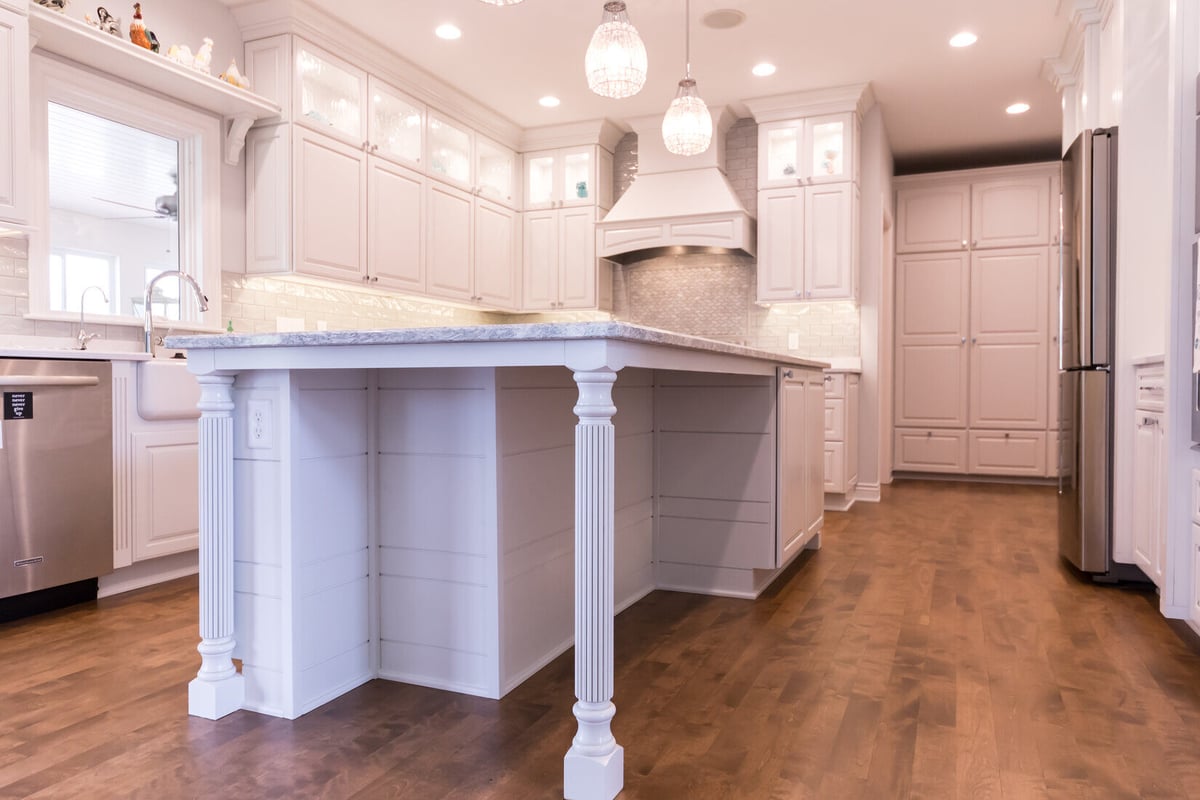 Close-up of kitchen island design with turned legs and ample storage in Grand Rapids Township by Ridgewood Home Construction