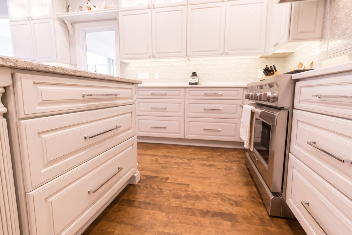 White shaker cabinets and rich wood floors in Grand Rapids Township kitchen remodel by Ridgewood Home Construction