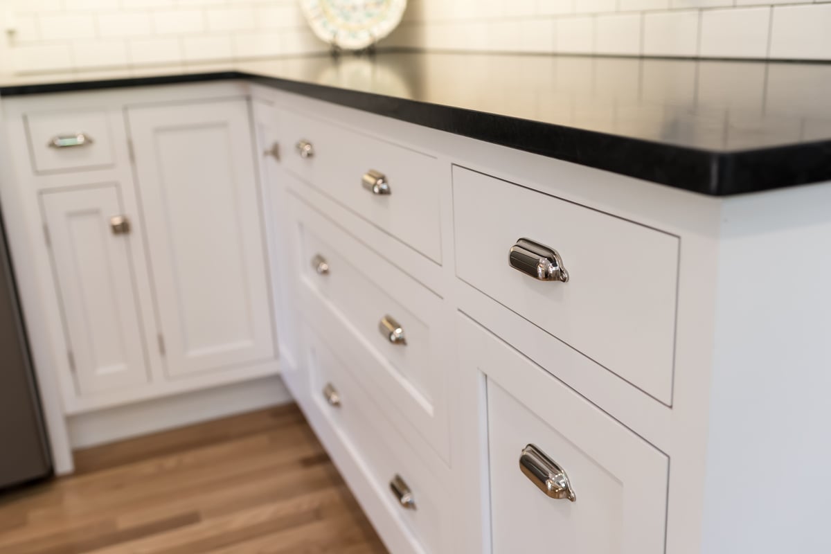 Close-up of white apron sink and chrome fixtures in Ridgewood Home Construction kitchen remodel in Rockford, MI