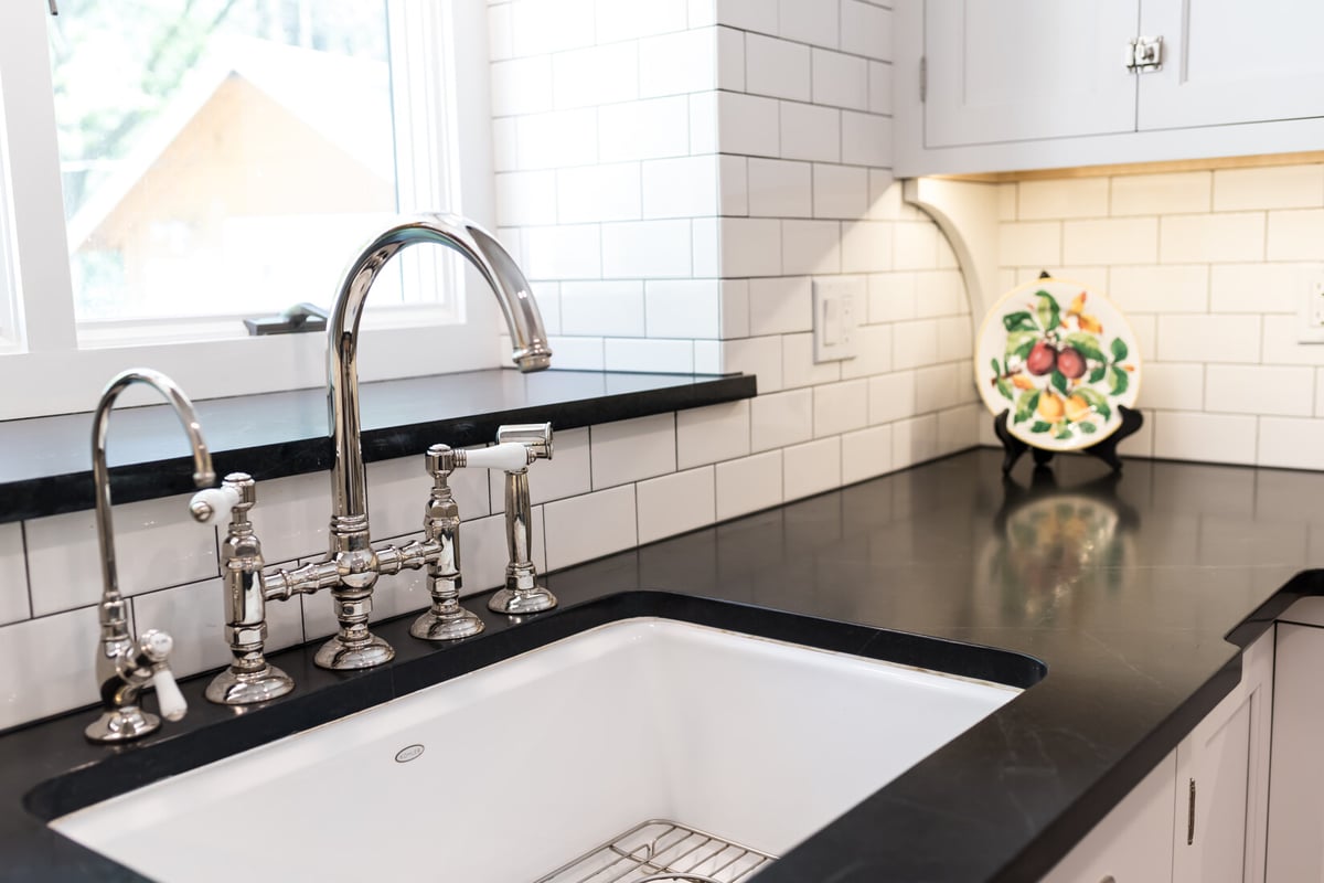 Detailed close-up of decorative dishes in cabinet in Ridgewood Home Construction kitchen remodel in Rockford, MI