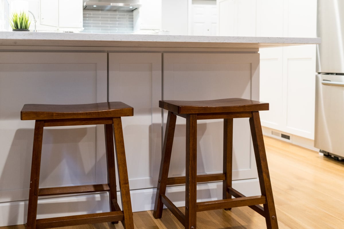 Kitchen island seating with wooden stools in a Ridgewood Home Construction remodel in Rockford, MI