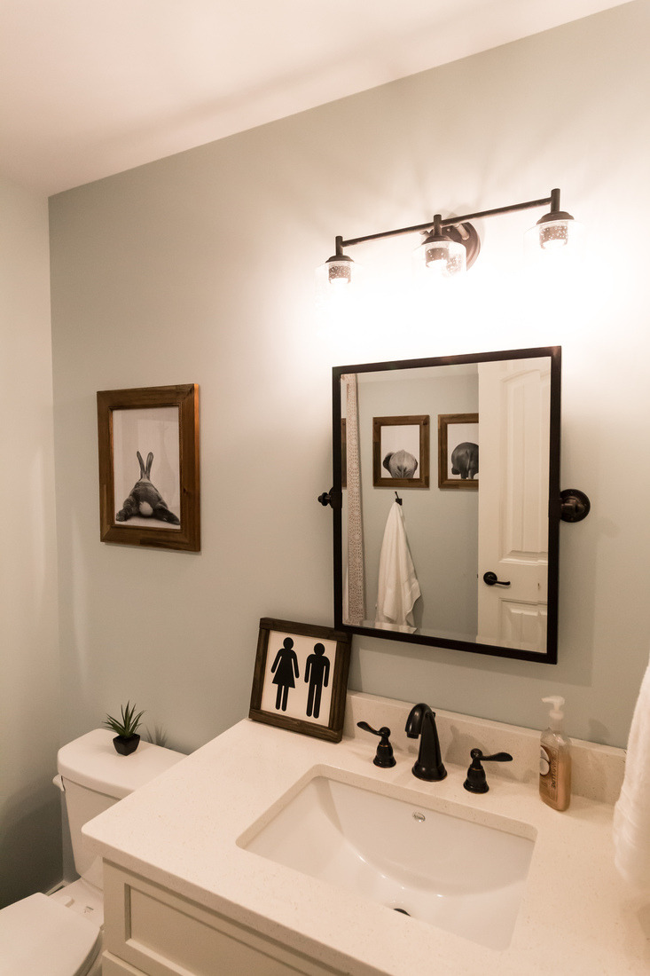 Basement bathroom remodel in Sparta, MI by Ridgewood Home Construction with modern black fixtures and wall decor