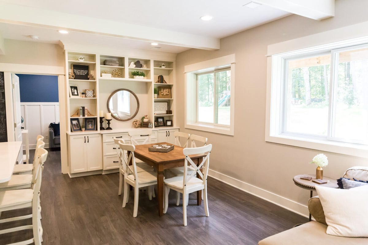 Bright basement dining and study area in Sparta, MI with white trim and wood furnishings by Ridgewood Home Construction